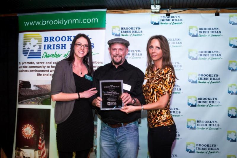 Annette Dupuie, left, presented Dan and Samantha Ross with a plaque naming their company, TransPharm Preclinical Solutions, as the Brooklyn-Irish Hills Chamber of Commerce Business of the Year for 2014.
